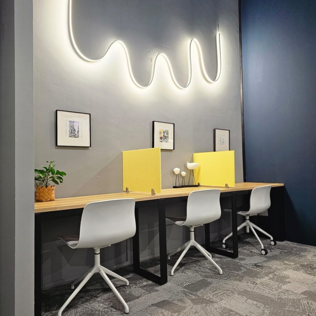 Hot desk row with neon lighting at Dott Co+work Woodlands