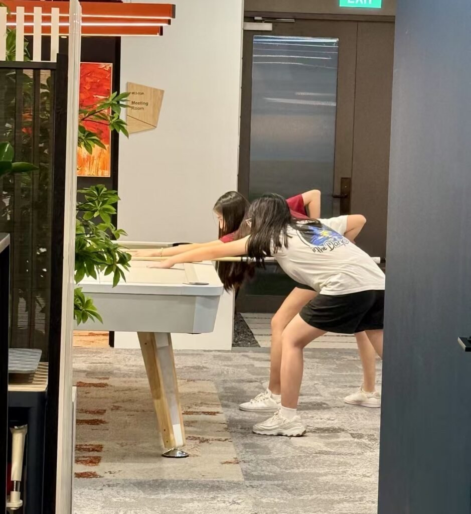 Guests playing pool at Dott Co+work Woodlands
