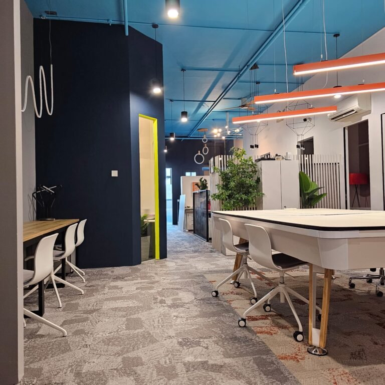 Open coworking area with hot desks and long shared tables at Dott Co+work Woodlands